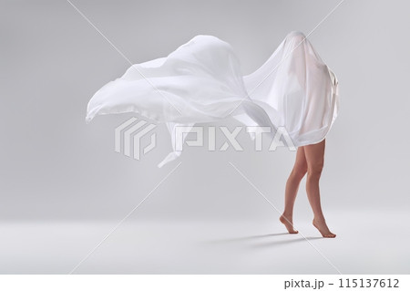 Unrecognizable bare woman wrapped in white fabric Unrecognizable bare woman wrapped in white fabric 115137612