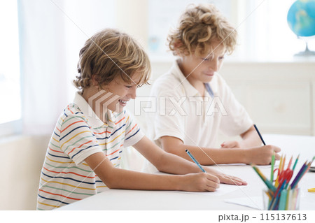 Child in school. Student in class. Boy at homework Child in school. Student in class. Boy at homework 115137613