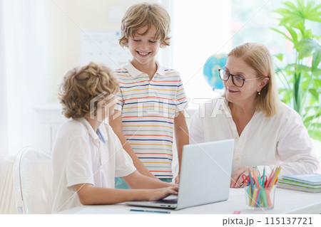 Child in school. Student in class. Boy at homework Child in school. Student in class. Boy at homework 115137721