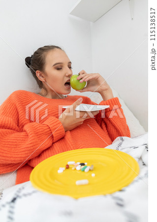 During illness, the teenager decided to eat a green apple full of vitamin C. 115138517