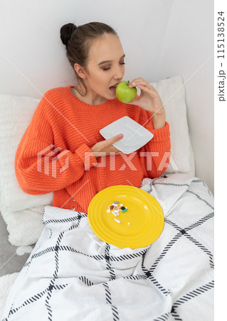 During illness, the teenager decided to eat a green apple full of vitamin C. 115138524
