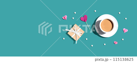 A cup of coffee with a gift box and hearts 115138625