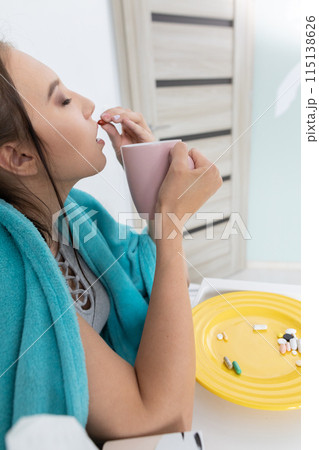 On the plate lies a set of tablets and vitamins as well as antibiotics that are necessary during every illness and cold. On the plate lies a set of tablets and vitamins as well as antibiotics that are necessary during every illness and cold. 115138626