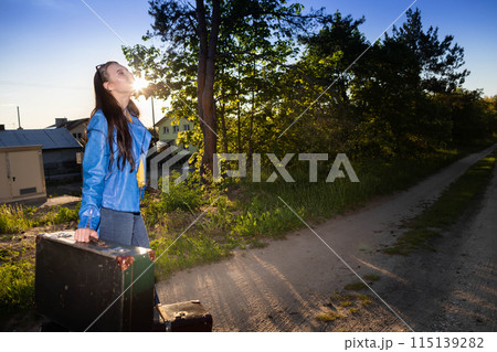The teenager has returned home to her country after a wonderful vacation trip and is waiting for her family to take her home. The teenager has returned home to her country after a wonderful vacation trip and is waiting for her family to take her home. 115139282