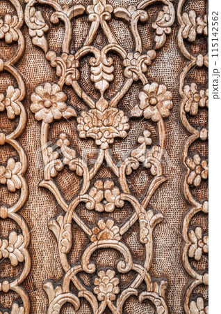 flower pattern Uzbek traditional ornament on wooden carved door in Tashkent in Uzbekistan closeup flower pattern Uzbek traditional ornament on wooden carved door in Tashkent in Uzbekistan closeup 115142562