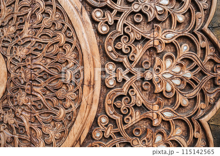oriental pattern Uzbek traditional ornament on wooden carved door in Tashkent in Uzbekistan 115142565