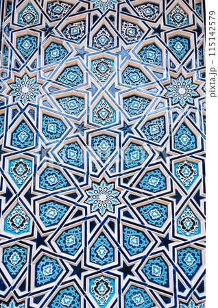 uzbek tile mosaic with traditional oriental Arabic Islamic pattern decorated with blue and white starry ornament with stars in Uzbekistan 115142579