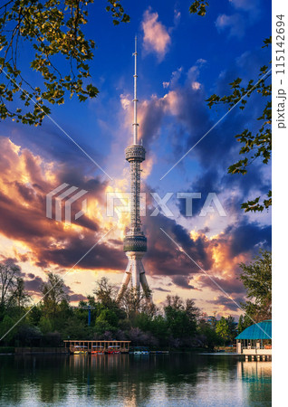 television TV tower in Tashkent in Uzbekistan with a reflection in the water of river under a beautiful blue sky in spring at sunset 115142694