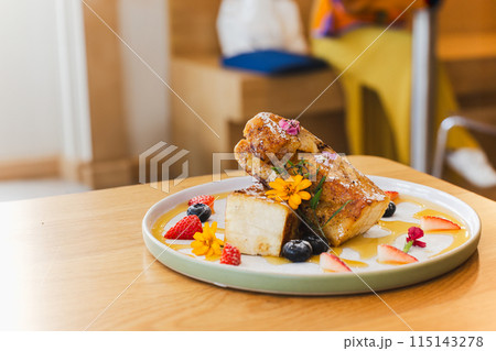 Delicious French toasts with strawberries and honey. 115143278