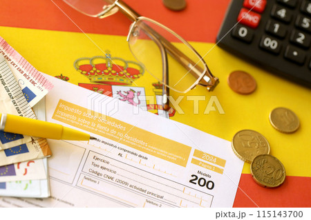 Modelo 200 spanish tax form for corporate income tax for non resident taxpayer lies on flag of Spain close up on accountant table Modelo 200 spanish tax form for corporate income tax for non resident taxpayer lies on flag of Spain close up on accountant table 115143700