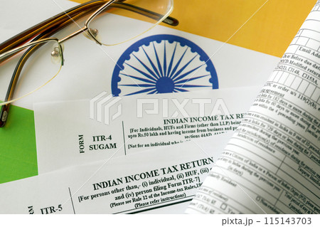 Indian income tax return blank form with pen and indian rupees bills on indian country flag close up. Annual tax report concept 115143703