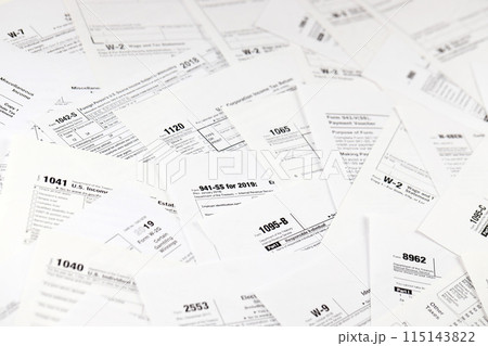 Many tax form blanks lies on table close up. Tax payers paperwork routine and bureaucracy concept. Need help with tax problems Many tax form blanks lies on table close up. Tax payers paperwork routine and bureaucracy concept. Need help with tax problems 115143822