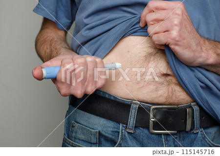 Man making Injection in her Stomach. Semaglutide or Insulin Injection Diabetes Drug 115145716