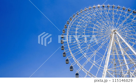 white big Ferris wheel on background a bright blue sky in amusement park at fair in summer with copy space 115146829