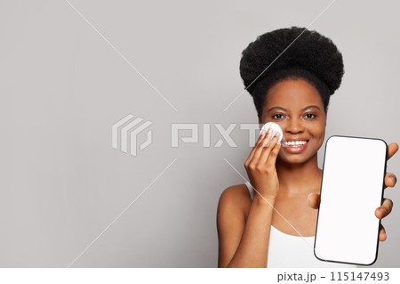 Glamorous healthy woman holding smartphone with white empty blank screen display  115147493