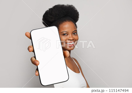Good-looking healthy woman holding smartphone with white empty blank screen display  115147494