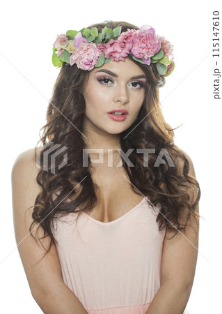 Fashionable brunette woman with fresh flower on her head. Spring, cosmetic 115147610