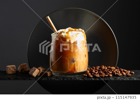 Iced coffee with whipped cream and caramel sauce. Iced coffee with whipped cream and caramel sauce. 115147935
