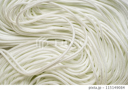 coils of white thin paracord background 115149084