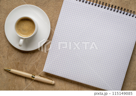 blank spiral notebook with grid paper, flat lay with coffee on textured art paper 115149085