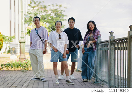 Group of Friends Posing by the Riverside Fence Group of Friends Posing by the Riverside Fence 115149360