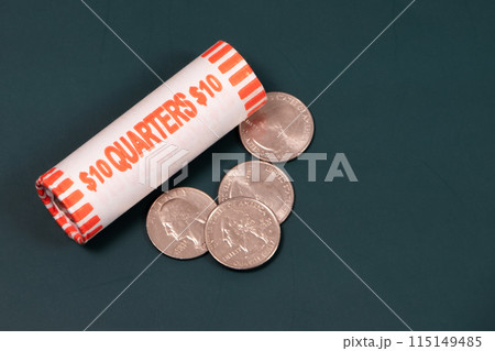 25 cent coins on a dark background, quarter dollar USA, laundromat coins 25 cent coins on a dark background, quarter dollar USA, laundromat coins 115149485
