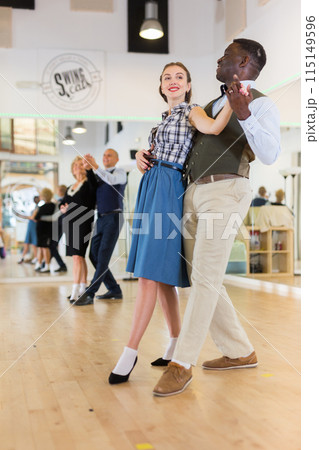 Woman and man dancing waltz in studio 115149596