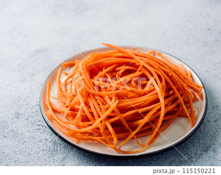 Raw carrot noodles or spaghetti, top view Raw carrot noodles or spaghetti, top view 115150221