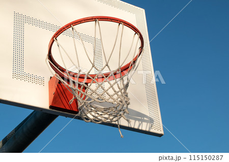 Basketball hoop against blue sky Basketball hoop against blue sky 115150287