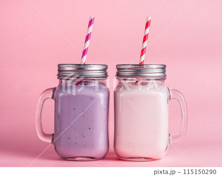 Strawberry and blueberry smoothie on pink Strawberry and blueberry smoothie on pink 115150290