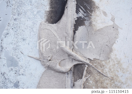 Dusty peeling paint wall background, texture of a concrete old wall with stains and cracks Dusty peeling paint wall background, texture of a concrete old wall with stains and cracks 115150415
