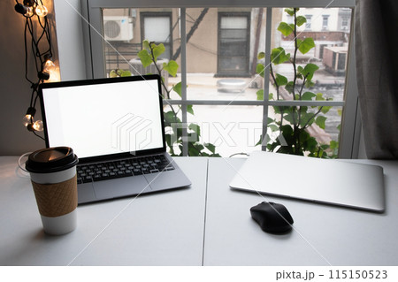 Home office, desktop with laptops and a cup of coffee, freelancer workplace, distant work, work from home Home office, desktop with laptops and a cup of coffee, freelancer workplace, distant work, work from home 115150523