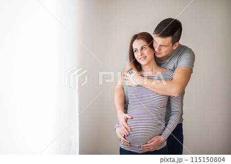 Pregnant woman and her partner, touching her belly. Pregnant woman and her partner, touching her belly. 115150804