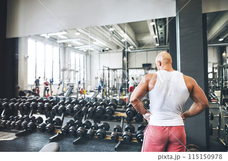 Close up of man choosing dumbbell from rack. Routine workout for physical and mental health. Close up of man choosing dumbbell from rack. Routine workout for physical and mental health. 115150978