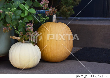 Pumpkins on the steps, Halloween porch decorations, autumn background, colorful fall vegetables Pumpkins on the steps, Halloween porch decorations, autumn background, colorful fall vegetables 115152157