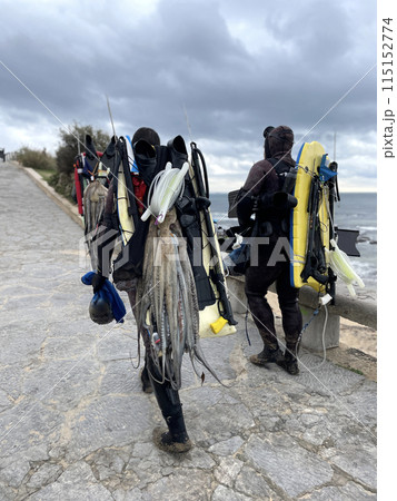 Divers with spearguns and catch walking on Divers with spearguns and catch walking on 115152774