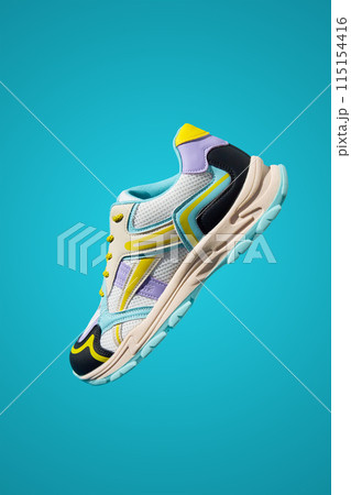 Fashionable Sneaker on blue background. Creative banner with stylish shoes Fashionable Sneaker on blue background. Creative banner with stylish shoes 115154416