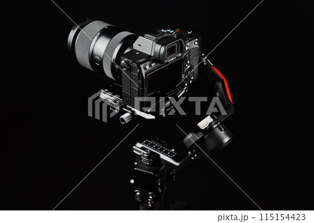Camera mounted on electronic gimbal in studio lighting Camera mounted on electronic gimbal in studio lighting 115154423