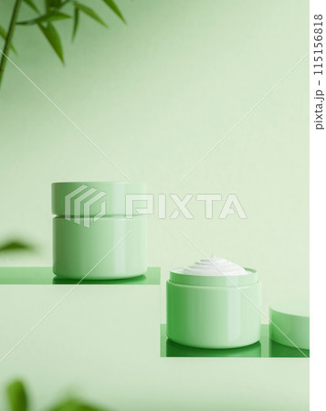Two green jar of cream on pedestal on green background with green leaf. organic beauty products Two green jar of cream on pedestal on green background with green leaf. organic beauty products 115156818