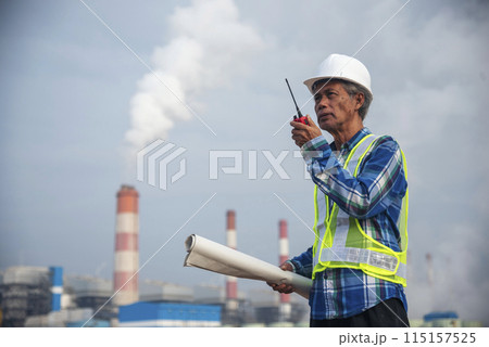 Senior Electrician engineer man hand holding red Walkie talkie communicate wear White hardhat at Power stations manufacturing electrical plant. Technician worker blue hard hat helmet Engineer industry Senior Electrician engineer man hand holding red Walkie talkie communicate wear White hardhat at Power stations manufacturing electrical plant. Technician worker blue hard hat helmet Engineer industry 115157525