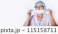 Elderly mature woman doctor or nurse in a white medical coat, gloves, puts on face mask wearing personal protective equiment isolated. Healthcare and medicine concept. Covid-19 pandemic 115158711