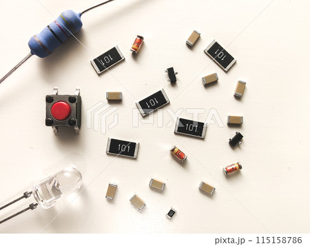 Electronic components, ceramic capacitors, transistor, diode and resistors on background white Electronic components, ceramic capacitors, transistor, diode and resistors on background white 115158786
