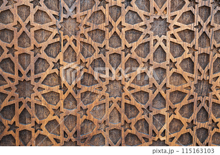 arabic Uzbek Islamic patterns ornament with stars on wooden carved door in Uzbekistan close-up arabic Uzbek Islamic patterns ornament with stars on wooden carved door in Uzbekistan close-up 115163103