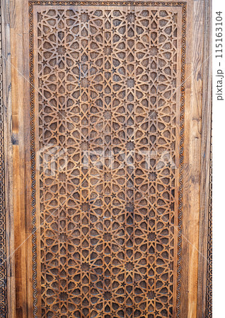 arabic Uzbek Islamic patterns ornament with stars on a modern wooden carved door in Uzbekistan arabic Uzbek Islamic patterns ornament with stars on a modern wooden carved door in Uzbekistan 115163104