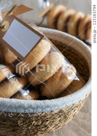 Homemade cookies in a bag inside a basket Homemade cookies in a bag inside a basket 115163794