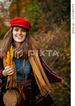 smiling elegant woman in jeans shirt and hat walking smiling elegant woman in jeans shirt and hat walking 115166205
