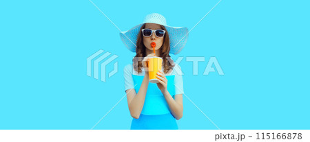 Summer portrait of beautiful young woman with cup of fresh juice wearing hat on blue background Summer portrait of beautiful young woman with cup of fresh juice wearing hat on blue background 115166878