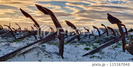 Rusty old anchors on the beach at the Anchor Cemetary graveyard at Praia do Barril beach in Tavira, Algarve, Portugal Rusty old anchors on the beach at the Anchor Cemetary graveyard at Praia do Barril beach in Tavira, Algarve, Portugal 115167048