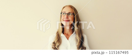 Happy smiling caucasian middle aged woman employee looking away thinking on white background 115167495