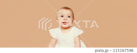 Portrait happy cute baby crawling on the floor on brown studio background Portrait happy cute baby crawling on the floor on brown studio background 115167596